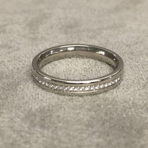 28 - Platinum and diamond set band, half set with channel set single cut diamonds size J 4.6g