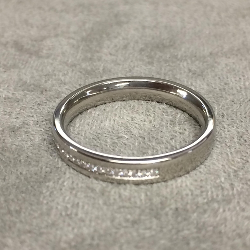 28 - Platinum and diamond set band, half set with channel set single cut diamonds size J 4.6g