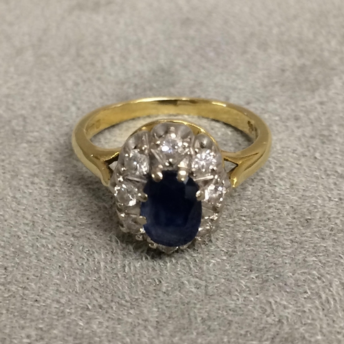 30 - 18ct gold sapphire and diamond dress ring central oval free cut sapphire, 8mm & 6mm, with a surround... 