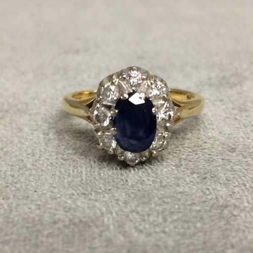 30 - 18ct gold sapphire and diamond dress ring central oval free cut sapphire, 8mm & 6mm, with a surround... 