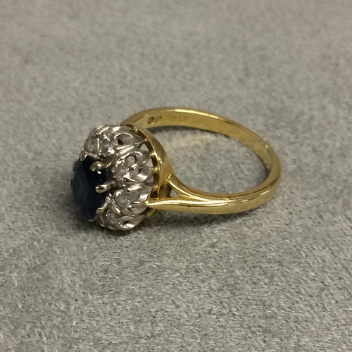 30 - 18ct gold sapphire and diamond dress ring central oval free cut sapphire, 8mm & 6mm, with a surround... 