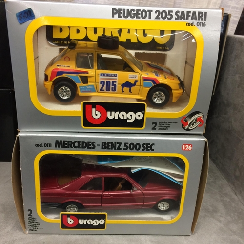 395 - A collection of Burago die cast metal boxed toy cars of various scales to include a Mercedes Benz 50... 