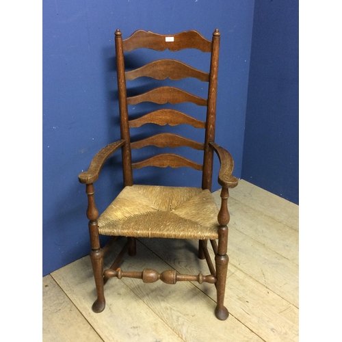 478 - An oak ladder back rush seated arm chair 115cm H x 61.5cm W x 43cm to top of seat x 41cm from back t... 