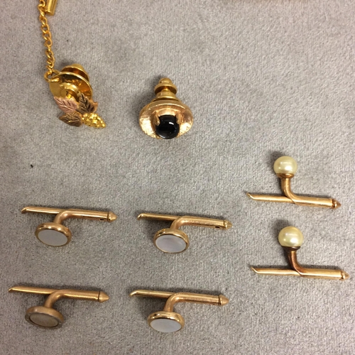 48 - Collection of unmarked yellow and white metal dress items to include cufflinks, dress studs, and oth... 