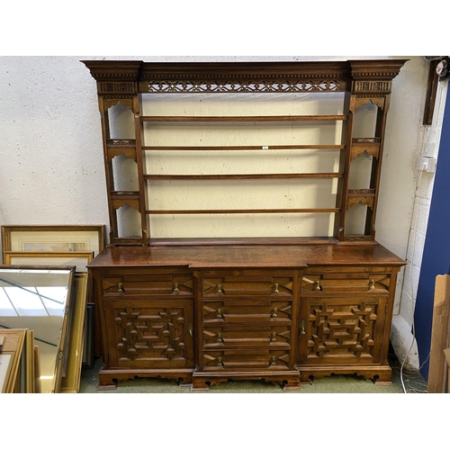 504 - C17th style oak breakfront dresser, with geometric carved panel cupboard doors,  together with oak d... 