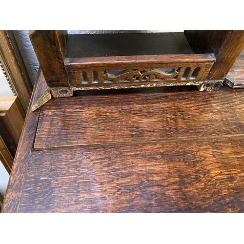 504 - C17th style oak breakfront dresser, with geometric carved panel cupboard doors,  together with oak d... 