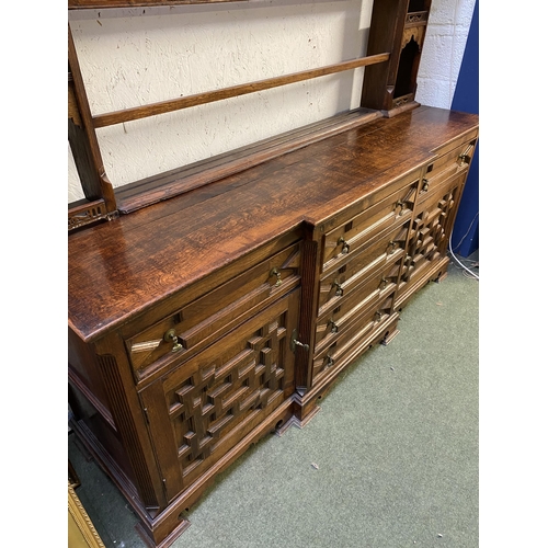 504 - C17th style oak breakfront dresser, with geometric carved panel cupboard doors,  together with oak d... 