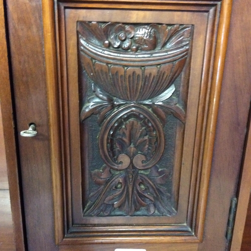 505 - Mahogany hanging cupboard, with raised carved floral panel to front