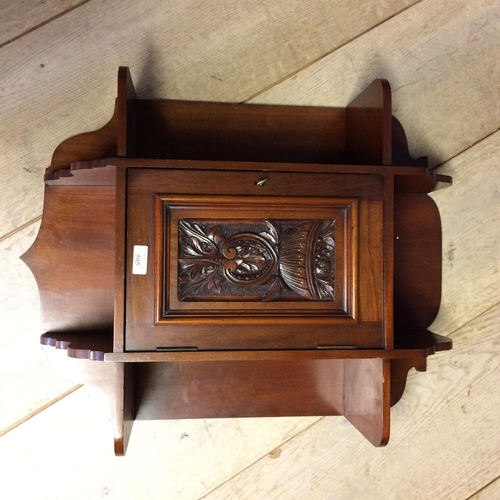 505 - Mahogany hanging cupboard, with raised carved floral panel to front