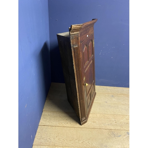 523 - Large oak hanging corner cupboard, with brass plates and handle129h x 86 w x 48 d cm