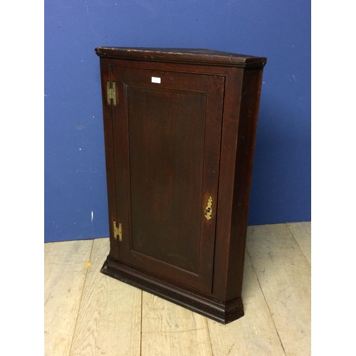 524 - Small dark oak hanging corner cupboard with brass hinges and with key 96h x 67 w x 33 d cm