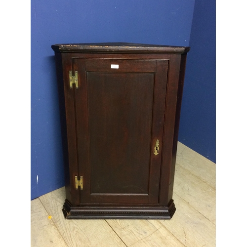 524 - Small dark oak hanging corner cupboard with brass hinges and with key 96h x 67 w x 33 d cm