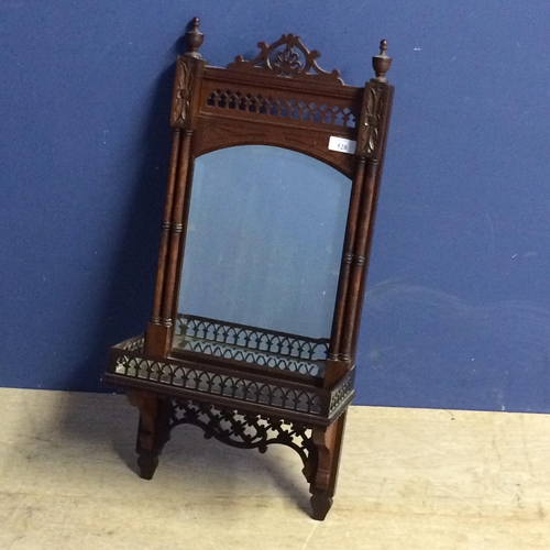 528 - Mahogany hanging wall mirror and shelf, with ornately carved fretwork design and finials