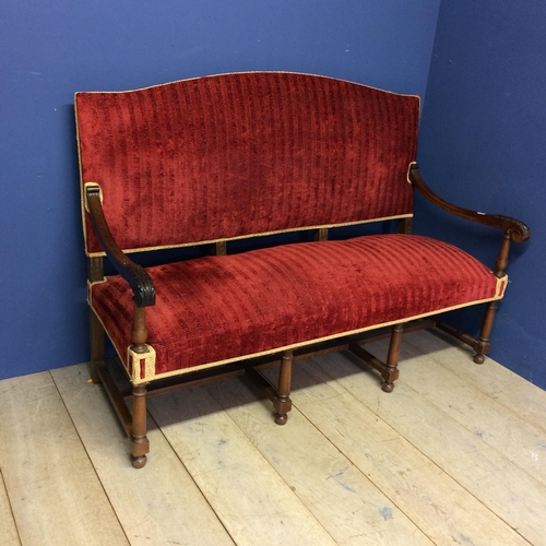 531 - A good heavy oak framed hall settee with carved scrolling arms, and with red upholstered overstuffed... 