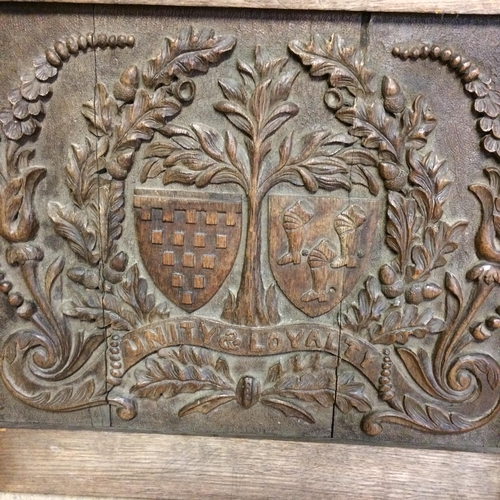 539 - Two elm stick back chairs, an carved oak panel, engraved crest inscribed with 