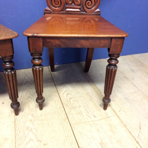 540 - Pair of mahogany shield shaped back hall chairs, with some wear and fading