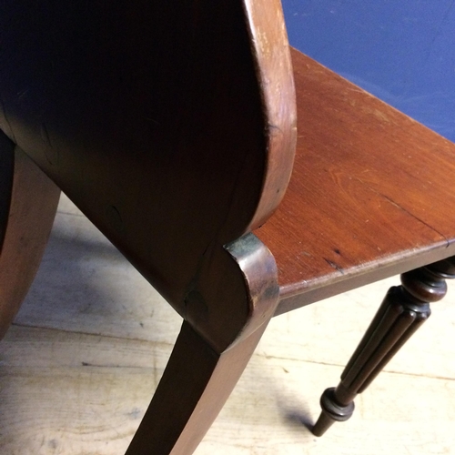 540 - Pair of mahogany shield shaped back hall chairs, with some wear and fading