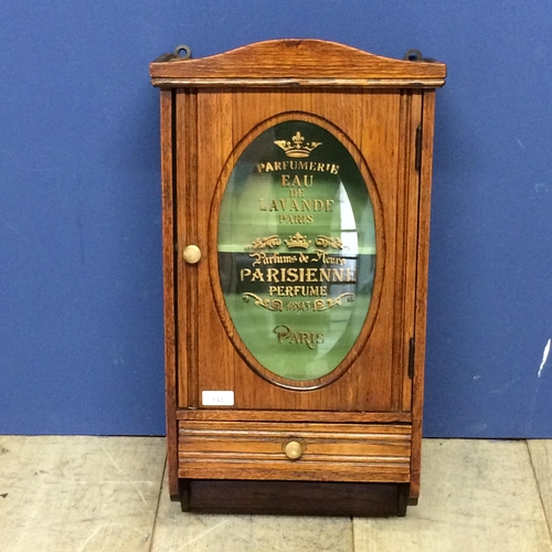 542 - An oak and glazed hanging wall cabinet, with drawer, the glass inscribed 