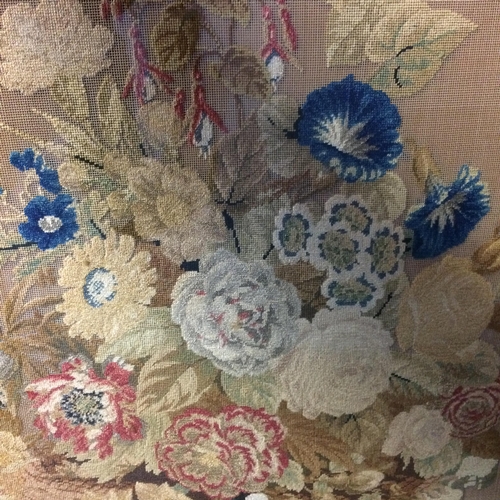 545 - Victorian fire screen, a floral tapestry beneath a glazed front, and with a decorative carved painte... 