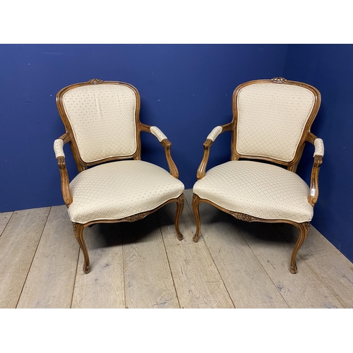 563 - Pair of French show frame style chairs, with cabriole legs, upholstered in a cream fabric, makers la... 