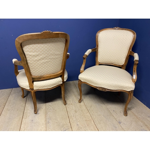 563 - Pair of French show frame style chairs, with cabriole legs, upholstered in a cream fabric, makers la... 