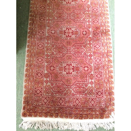 582 - Rugs: A Long red ground runner with all over geometric stylized patterns 72cm x 722cm