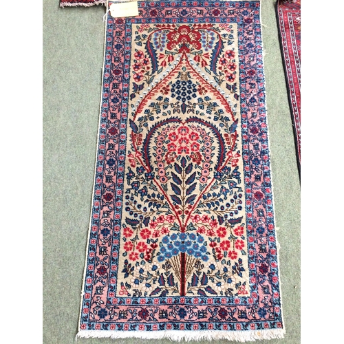 583 - 4 rugs, 3 red ground rugs with all over geometric stylized designs, and a blue and red ground Tree o... 