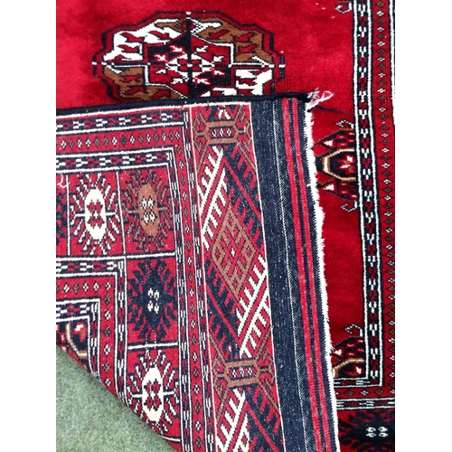 583 - 4 rugs, 3 red ground rugs with all over geometric stylized designs, and a blue and red ground Tree o... 