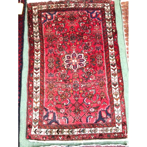 583 - 4 rugs, 3 red ground rugs with all over geometric stylized designs, and a blue and red ground Tree o... 