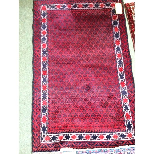 583 - 4 rugs, 3 red ground rugs with all over geometric stylized designs, and a blue and red ground Tree o... 