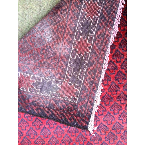 583 - 4 rugs, 3 red ground rugs with all over geometric stylized designs, and a blue and red ground Tree o... 