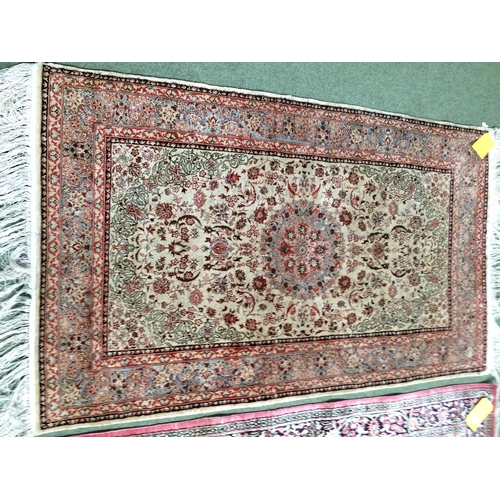 584 - 2 silk rugs, 158 x 102cm; 153 x 93cm, one with square green panel ground and red geometric wide bord... 