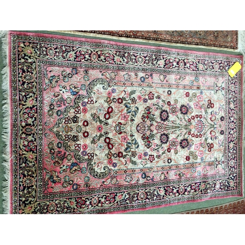 584 - 2 silk rugs, 158 x 102cm; 153 x 93cm, one with square green panel ground and red geometric wide bord... 