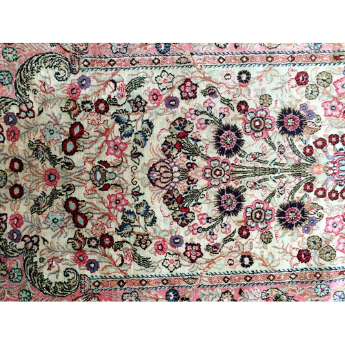 584 - 2 silk rugs, 158 x 102cm; 153 x 93cm, one with square green panel ground and red geometric wide bord... 