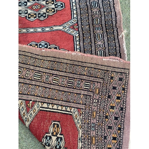 586 - 3 rugs:  a runner with red border and blue and floral central panel, and 2 smaller red and blue patt... 