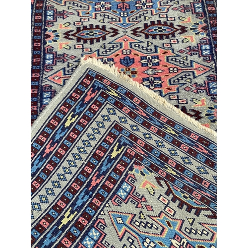 586 - 3 rugs:  a runner with red border and blue and floral central panel, and 2 smaller red and blue patt... 