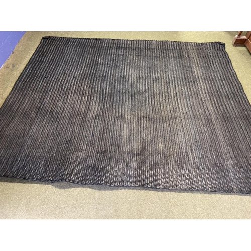 589 - A good heavy pile black wovern rug, 298 x 241cm