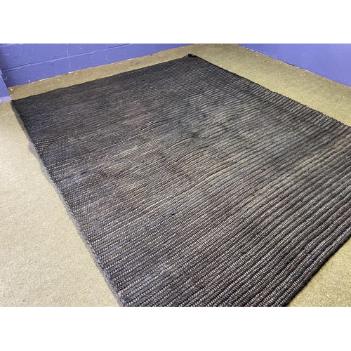 589 - A good heavy pile black wovern rug, 298 x 241cm