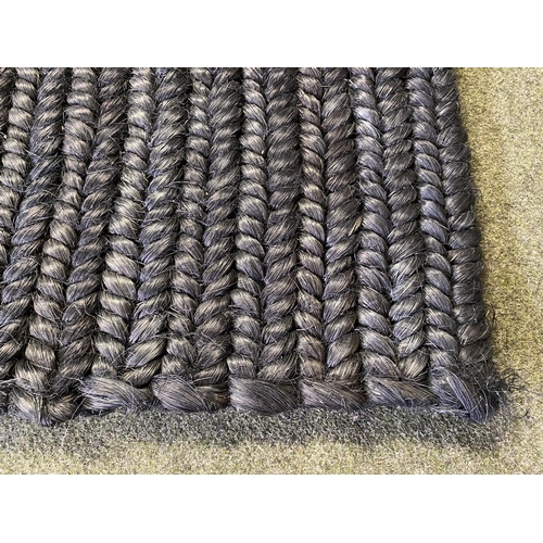 589 - A good heavy pile black wovern rug, 298 x 241cm