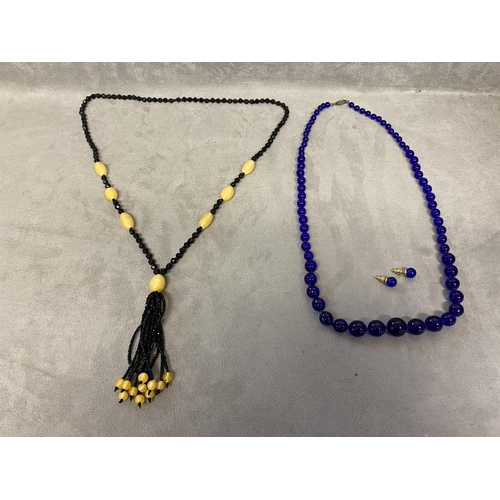 72 - Cobalt/Bristol blue graduated circular bead necklace, and matchin ear studs,  and a jet and amber st... 