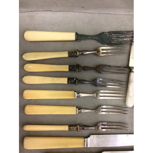 77 - A large quantity of flatware, including bone handled knives and forks etc and knife rests