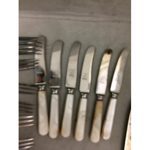 77 - A large quantity of flatware, including bone handled knives and forks etc and knife rests