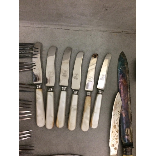 77 - A large quantity of flatware, including bone handled knives and forks etc and knife rests