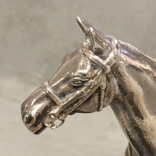 78 - Sterling silver model of a seated polo player on a polo pony,  with Sterling silver polo mallett, by... 