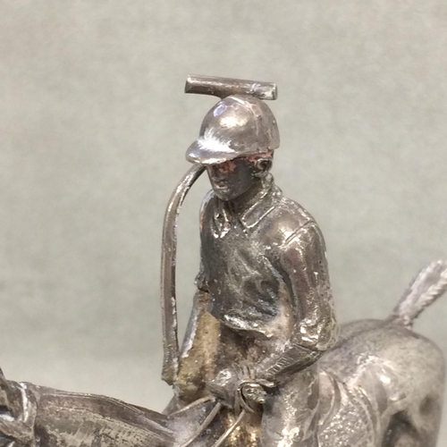 78 - Sterling silver model of a seated polo player on a polo pony,  with Sterling silver polo mallett, by... 