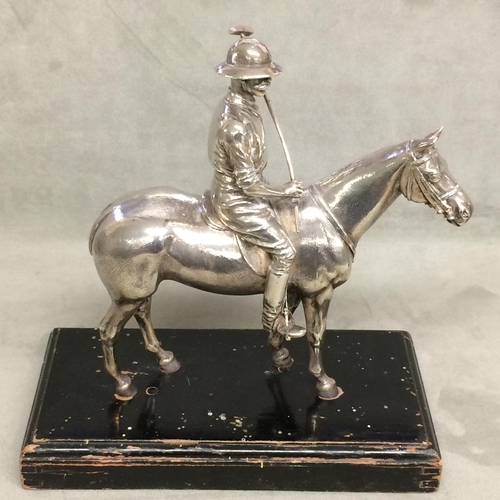 78 - Sterling silver model of a seated polo player on a polo pony,  with Sterling silver polo mallett, by... 