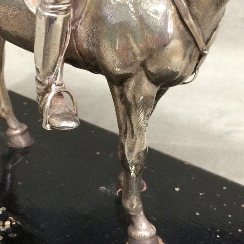 78 - Sterling silver model of a seated polo player on a polo pony,  with Sterling silver polo mallett, by... 