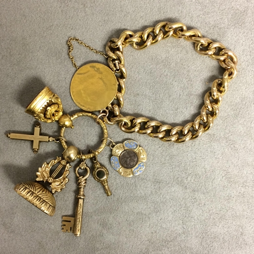 90 - 15ct gold flat curb link charm bracelet with spade guinea, 2 gilt metal watch fobs, 9 ct cross and 2... 