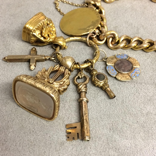 90 - 15ct gold flat curb link charm bracelet with spade guinea, 2 gilt metal watch fobs, 9 ct cross and 2... 