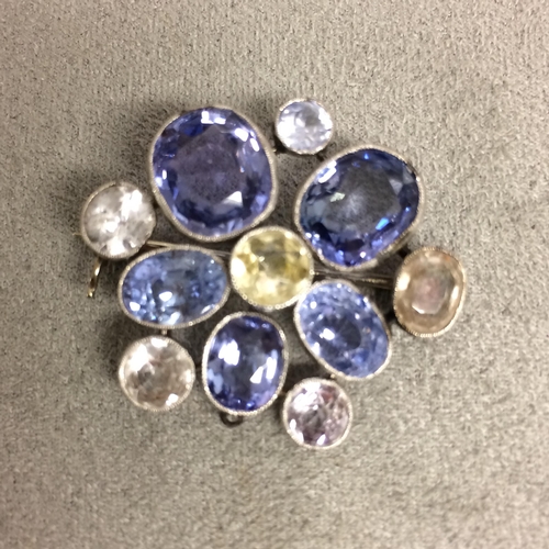 97 - Unmarked white metal sapphire and fancy sapphire  brooch 9.7g (some inclusions to one of the big blu... 